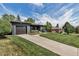 Beautiful single-story home with a well-manicured lawn, gray brick facade, and an attached garage at 4930 Gray St, Denver, CO 80212