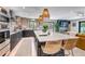 Bright, modern kitchen featuring a large island, stainless steel appliances, and designer lighting at 4930 Gray St, Denver, CO 80212