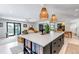 Open concept kitchen with large island with breakfast bar and connection to the living room at 4930 Gray St, Denver, CO 80212