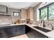 Well-equipped kitchen features elegant cabinets, countertops, and backsplash, complemented by modern appliances at 4930 Gray St, Denver, CO 80212