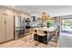 Modern kitchen with stainless steel appliances, a large island, and stylish pendant lighting, great for cooking at 4930 Gray St, Denver, CO 80212