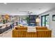 Open-concept living room with a view of the kitchen, a fireplace, and sliding glass doors leading to the patio at 4930 Gray St, Denver, CO 80212