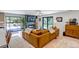 Stylish living room with a modern fireplace, plush sectional sofa, and sliding glass doors to the outdoor patio at 4930 Gray St, Denver, CO 80212
