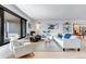 Bright living room features hardwood floors, a large picture window, and neutral furnishings at 4930 Gray St, Denver, CO 80212