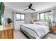 Relaxing main bedroom with a ceiling fan, large windows, and a comfortable, inviting bed at 4930 Gray St, Denver, CO 80212