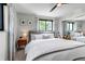 Cozy main bedroom featuring a ceiling fan, natural light, and a comfortable gray bed at 4930 Gray St, Denver, CO 80212