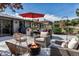 Inviting patio area with comfortable seating, a cozy fire pit, an umbrella, and a grill, perfect for outdoor entertaining at 4930 Gray St, Denver, CO 80212