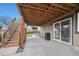 Outdoor patio area with ample space and stairs leading to a deck above, creating a multi-level outdoor oasis at 7262 Serena Dr, Castle Pines, CO 80108