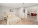 View of a basement bedroom with a bed, closet, and view into an adjacent living area with an open floorplan at 7262 Serena Dr, Castle Pines, CO 80108