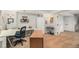 View of the basement office space with built-in desk, white storage cabinet, and adjacent carpeted area with stairs at 7262 Serena Dr, Castle Pines, CO 80108