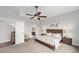 Serene bedroom with a ceiling fan, ensuite bathroom access, and soft neutral tones at 7262 Serena Dr, Castle Pines, CO 80108