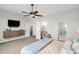 Well-lit bedroom with a TV, ceiling fan, and ensuite bathroom at 7262 Serena Dr, Castle Pines, CO 80108