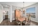 Dining room with a rustic table, hardwood floors, and plenty of natural light at 7262 Serena Dr, Castle Pines, CO 80108