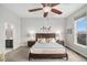 Comfortable main bedroom with a ceiling fan, large window, and ensuite bathroom entrance at 7262 Serena Dr, Castle Pines, CO 80108