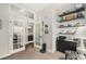 Bright office with french doors and custom shelving for storage and decor at 7262 Serena Dr, Castle Pines, CO 80108