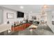 Well-equipped wet bar with granite countertops, cabinets, and a TV at 7262 Serena Dr, Castle Pines, CO 80108