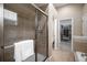 This bathroom features a glass door shower, and a walk-in closet with storage at 23951 E Easter Pl, Aurora, CO 80016