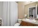 Bathroom featuring shower with curtain, single sink vanity, and tiled countertop at 23951 E Easter Pl, Aurora, CO 80016