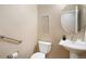 Clean half-bathroom with modern fixtures, pedestal sink, and neutral color palette at 23951 E Easter Pl, Aurora, CO 80016