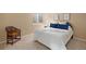 Comfortable bedroom with a queen size bed and pillows, chair and natural light from the window at 23951 E Easter Pl, Aurora, CO 80016