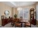 Charming dining room with a vintage grandfather clock, modern chandelier, and natural light at 23951 E Easter Pl, Aurora, CO 80016