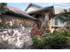 Charming entryway with wood stairs, stone accents, and lush landscaping detail at 23951 E Easter Pl, Aurora, CO 80016