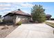 A home featuring stone accents and a spacious driveway is bathed in soft natural light at 23951 E Easter Pl, Aurora, CO 80016