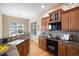 Bright kitchen with granite countertops, stainless appliances, and a window over the sink at 23951 E Easter Pl, Aurora, CO 80016