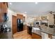 Open kitchen featuring granite countertops, breakfast bar, stainless appliances, and hardwood floors at 23951 E Easter Pl, Aurora, CO 80016