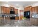 Spacious kitchen featuring granite countertops, stainless steel appliances, and ample cabinet space at 23951 E Easter Pl, Aurora, CO 80016