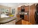 Well-lit kitchen featuring granite countertops, modern appliances, and eat-in breakfast bar at 23951 E Easter Pl, Aurora, CO 80016