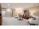 Open concept living room with a wooden hutch, carpet, and seating with throw pillows at 23951 E Easter Pl, Aurora, CO 80016