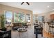 A bright and open living room connects to dining space with modern, comfortable furniture at 23951 E Easter Pl, Aurora, CO 80016