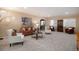 Cozy living room featuring plush carpet, comfortable seating, and an archway entrance at 23951 E Easter Pl, Aurora, CO 80016
