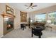 Bright living room featuring a cozy fireplace, plush seating, and sunny views at 23951 E Easter Pl, Aurora, CO 80016
