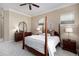 Comfortable bedroom with a four-poster bed, neutral decor, and natural light from the windows at 23951 E Easter Pl, Aurora, CO 80016