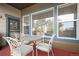 Outdoor patio with red flooring, seating, and view of backyard trees at 23951 E Easter Pl, Aurora, CO 80016