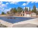 Backyard pool with cover, near house featuring stone accents and an outdoor staircase at 23951 E Easter Pl, Aurora, CO 80016