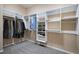 Spacious walk-in closet with carpet flooring and built in closet system with hanging racks and shelves at 23951 E Easter Pl, Aurora, CO 80016
