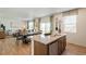 Open concept kitchen with island and stainless steel sink, seamlessly connected to the dining and living areas at 6543 12Th St, Frederick, CO 80530