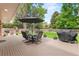 Spacious backyard deck features an umbrella-covered dining set and grill, ideal for outdoor entertaining at 5061 S Florence Dr, Englewood, CO 80111