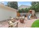 Backyard sitting area with a fire pit, Adirondack chairs, and a play structure at 5061 S Florence Dr, Englewood, CO 80111