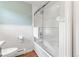 A clean white bathroom with a glass door shower and a toilet at 5061 S Florence Dr, Englewood, CO 80111
