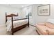 Comfortable bedroom with a floral bed set, an ornate wooden bed frame, and a bright window at 5061 S Florence Dr, Englewood, CO 80111