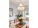 Close up shot of decorative chandelier and dining room table with seating for six at 5061 S Florence Dr, Englewood, CO 80111