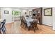 Dining area with natural light, hardwood floors, and a view of the backyard at 5061 S Florence Dr, Englewood, CO 80111