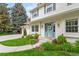 Inviting two-story home boasts a well-manicured lawn and a charming blue front door and entry at 5061 S Florence Dr, Englewood, CO 80111