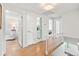 Upstairs hallway with hardwood floors leading to multiple rooms including a bathroom and bedroom at 5061 S Florence Dr, Englewood, CO 80111
