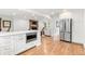 Open kitchen with stainless steel appliances, white cabinets and view of living area at 5061 S Florence Dr, Englewood, CO 80111