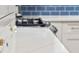 Close-up detail of white countertop and cabinets with elegant crystal knobs at 5061 S Florence Dr, Englewood, CO 80111